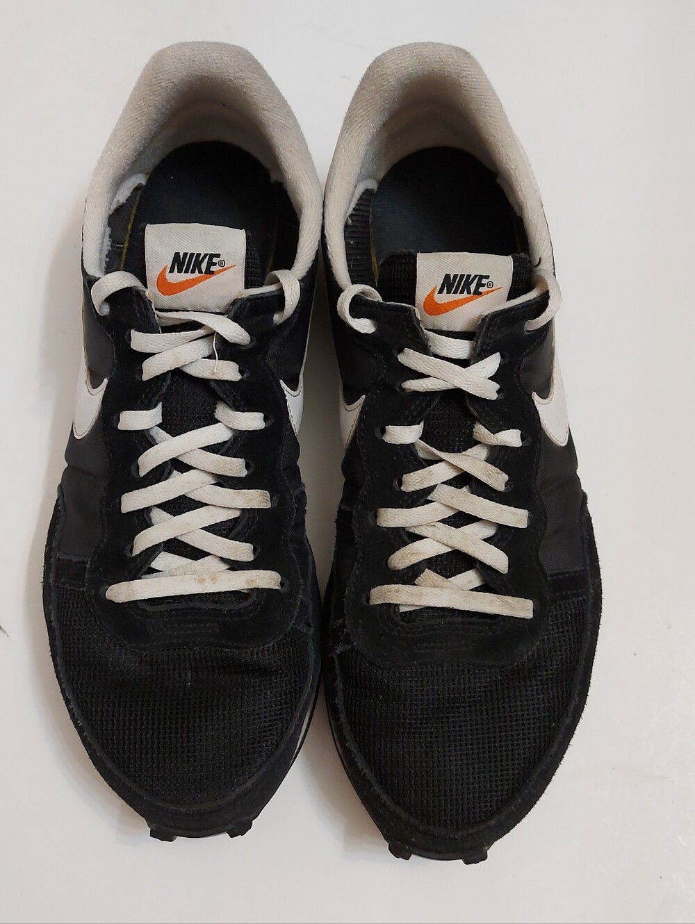 Nike Men’s Black & White Sneakers with Orange Logo
